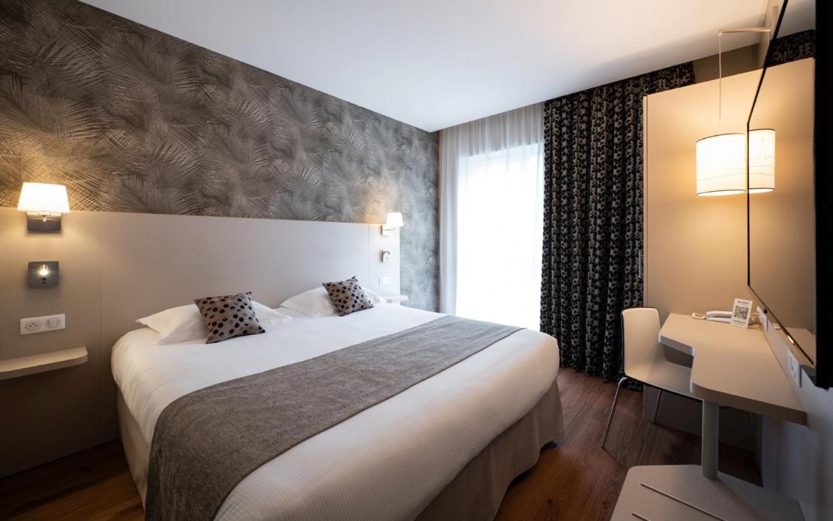 Un ou plusieurs lits dans un hébergement de l'établissement Kyriad Prestige Saint-Malo