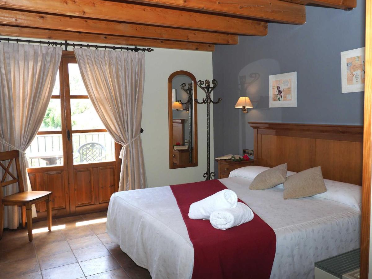 Un dormitorio con una cama con toallas. en Hotel & SPA Peña Montañesa, en Aínsa