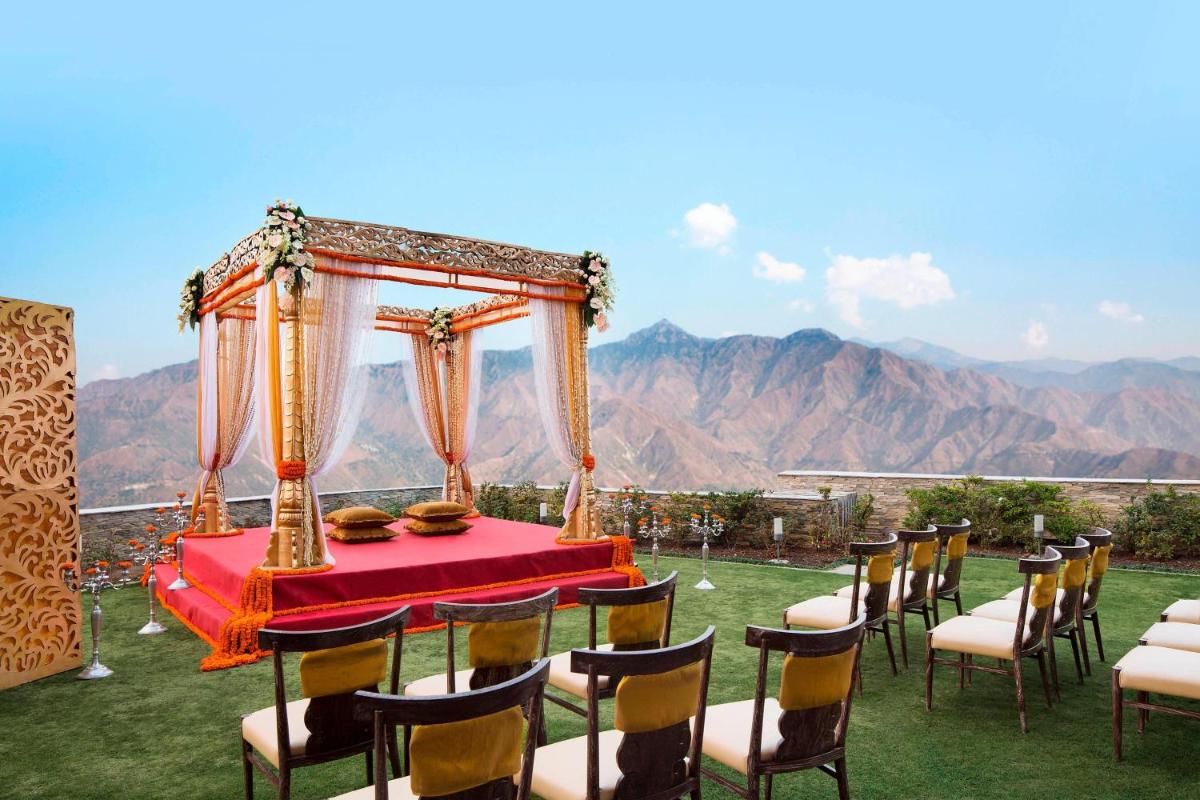 a table and chairs with a table and a canopy at JW Marriott Mussoorie Walnut Grove Resort & Spa in Mussoorie