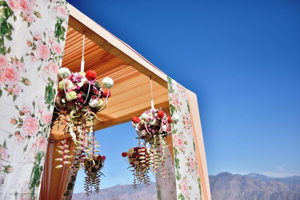 a bunch of flowers are hanging from a tent at JW Marriott Mussoorie Walnut Grove Resort & Spa in Mussoorie