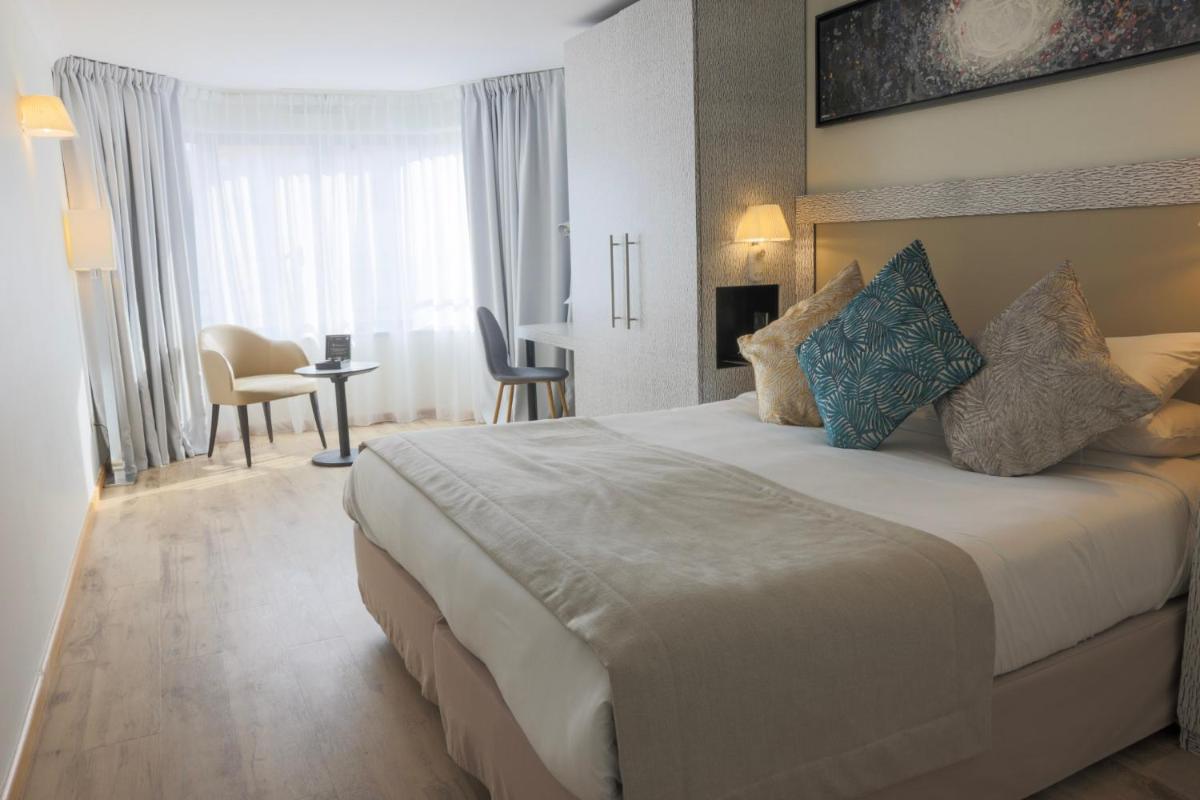 Un ou plusieurs lits dans un hébergement de l'établissement Eden Hotel & Spa