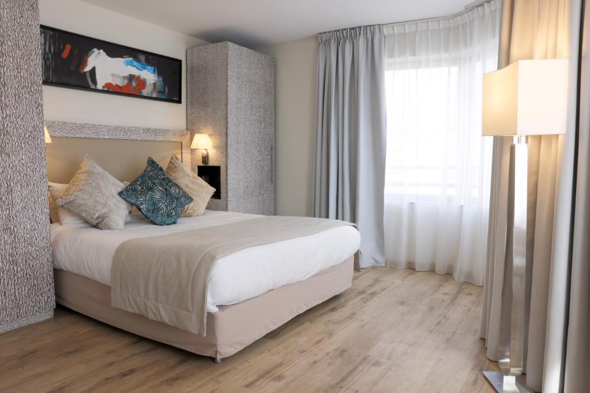 Un ou plusieurs lits dans un hébergement de l'établissement Eden Hotel & Spa