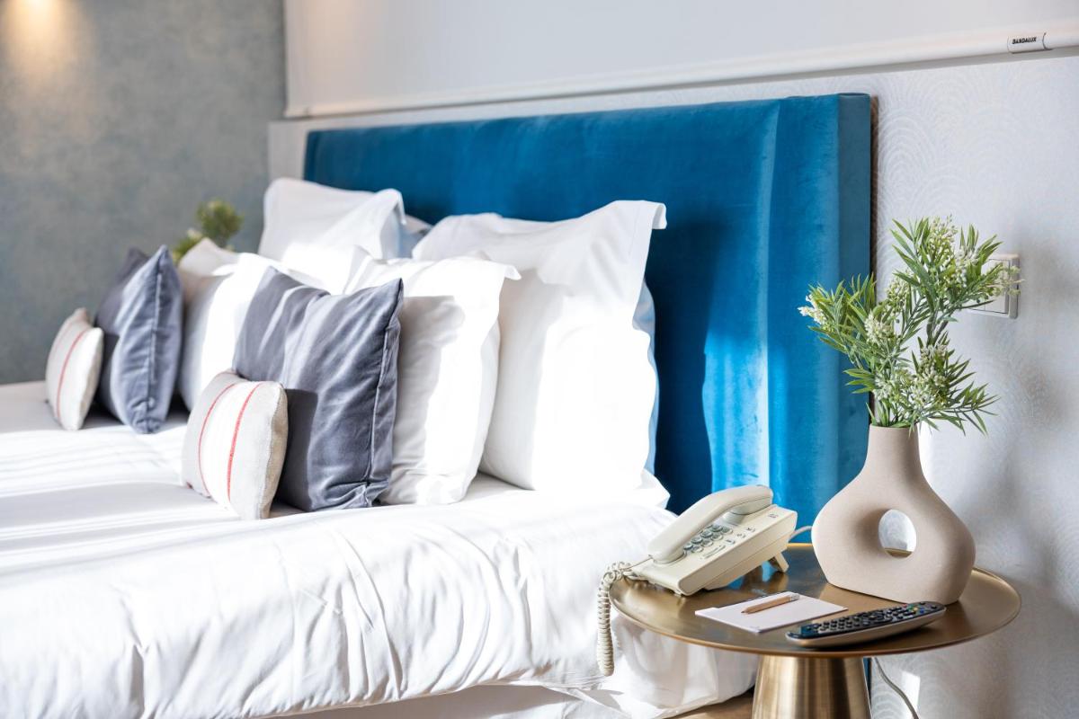 Uma cama ou camas num quarto em Pestana Cidadela Cascais - Pousada & Art District