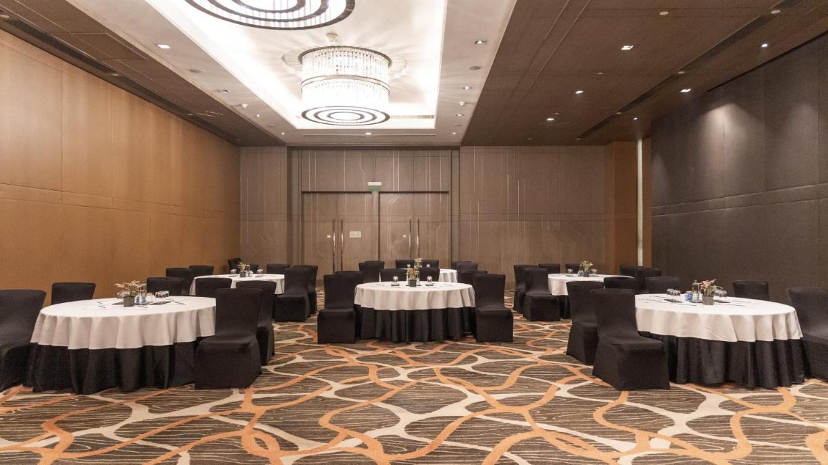 a conference room with tables and chairs in it at Holiday Inn New Delhi Aerocity by IHG in New Delhi