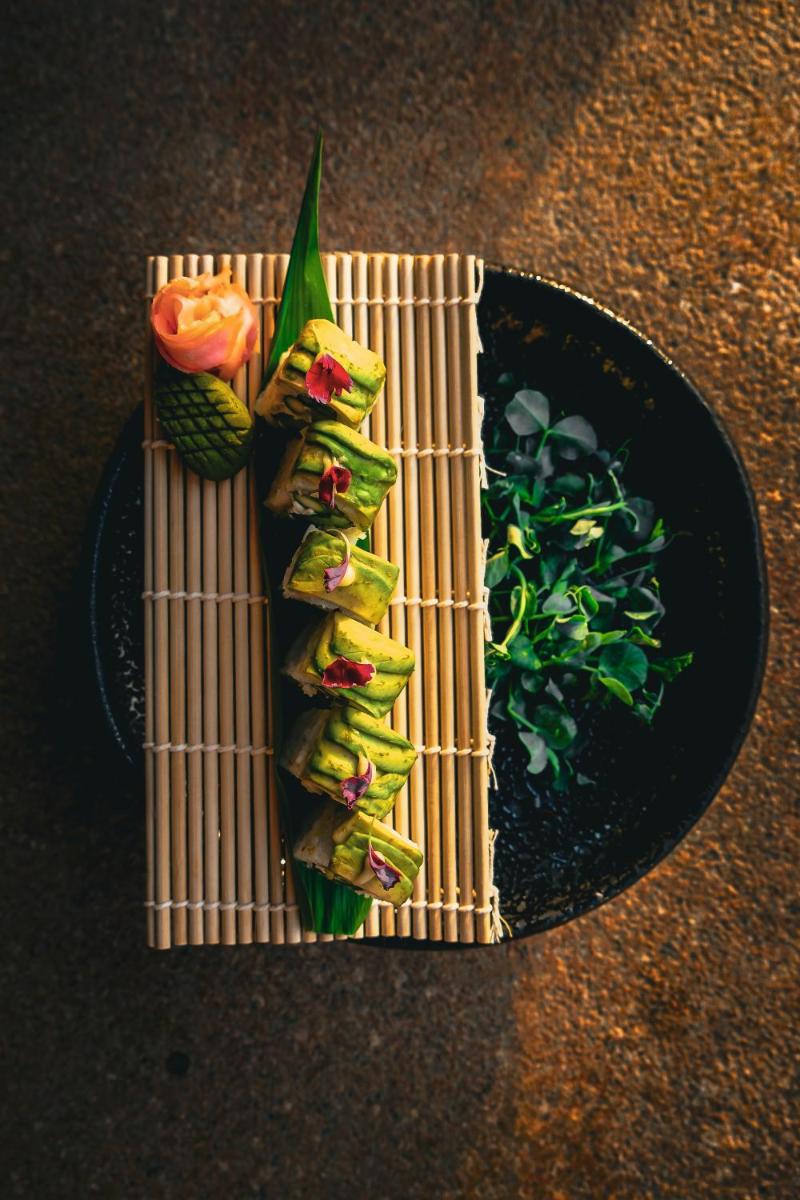 a plate of food with sushi and vegetables on it at Fairmont Jaipur in Jaipur