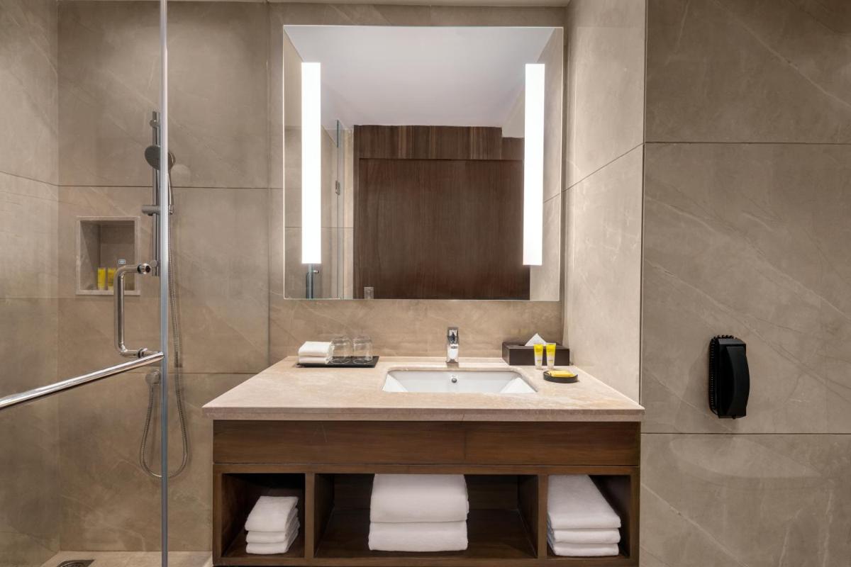 a bathroom with a sink and a shower at Hyatt Place Haridwar in Haridwār +20 photos