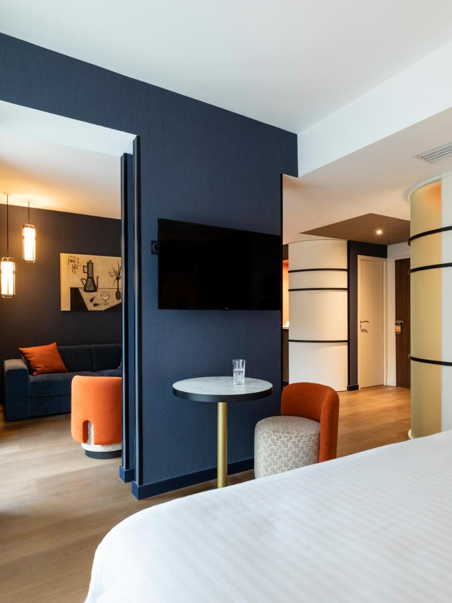 Télévision ou salle de divertissement dans l'établissement Hôtel & Spa Oceania Le Conti