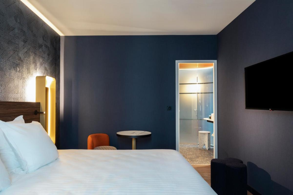 Un ou plusieurs lits dans un hébergement de l'établissement Hôtel & Spa Oceania Le Conti