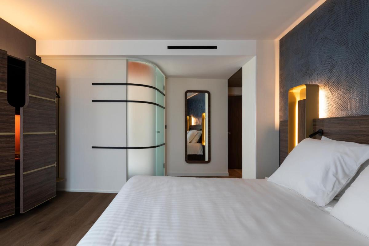 Un ou plusieurs lits dans un hébergement de l'établissement Hôtel & Spa Oceania Le Conti