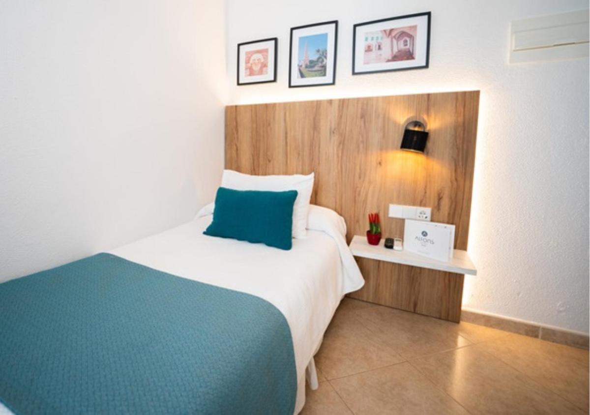 Cama o camas de una habitación en Alfons Hotel
