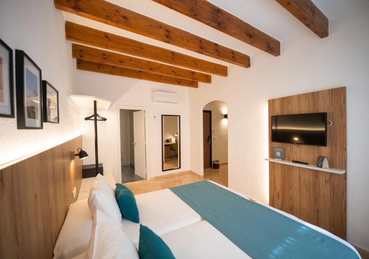 Cama o camas de una habitación en Alfons Hotel