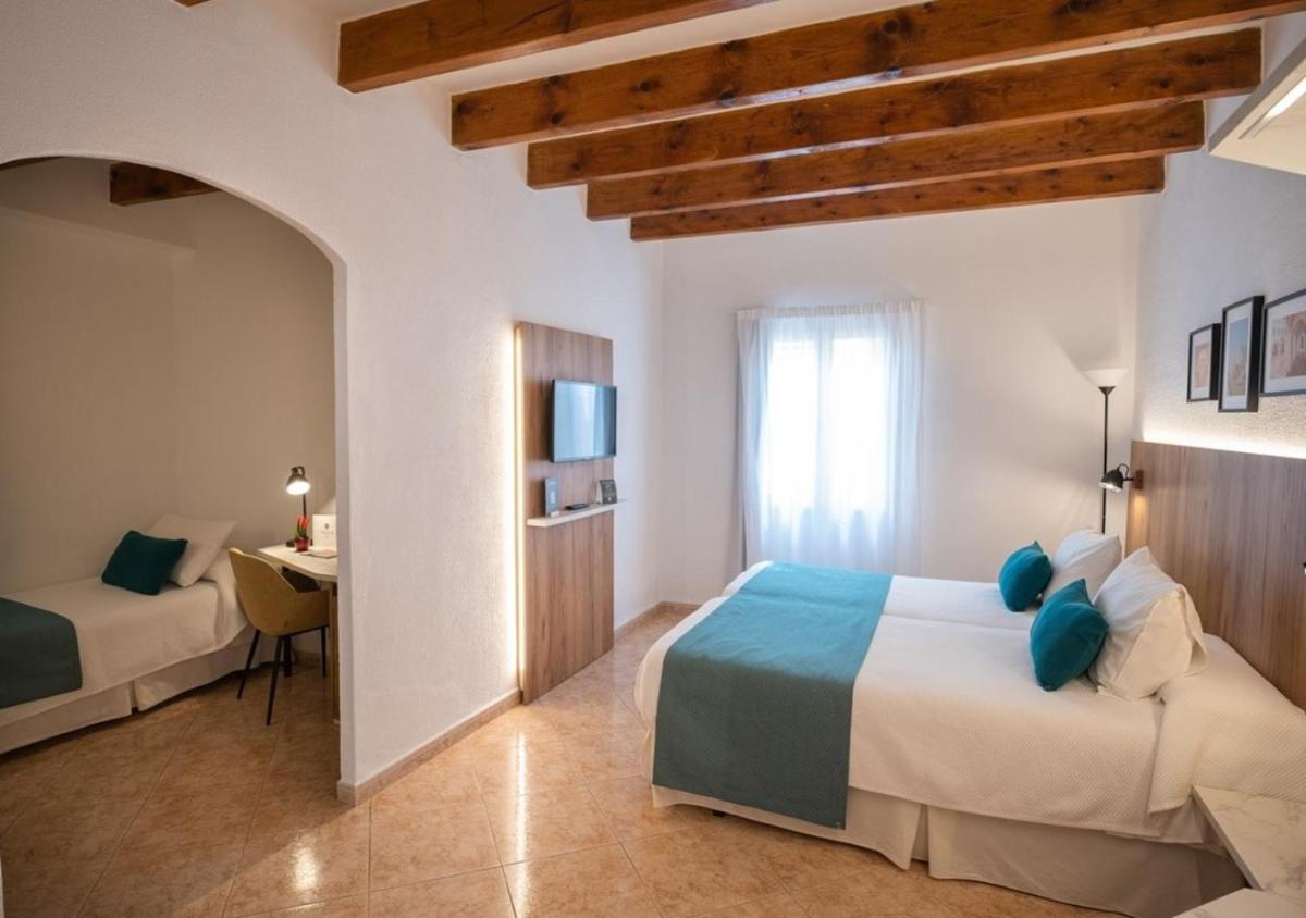Cama o camas de una habitación en Alfons Hotel