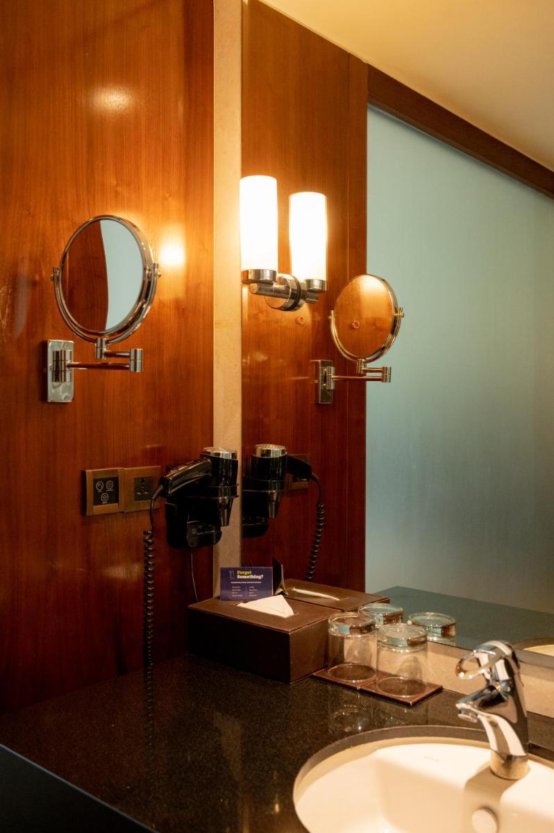 a bathroom with a sink and a mirror at DoubleTree by Hilton-Pune Chinchwad in Pune