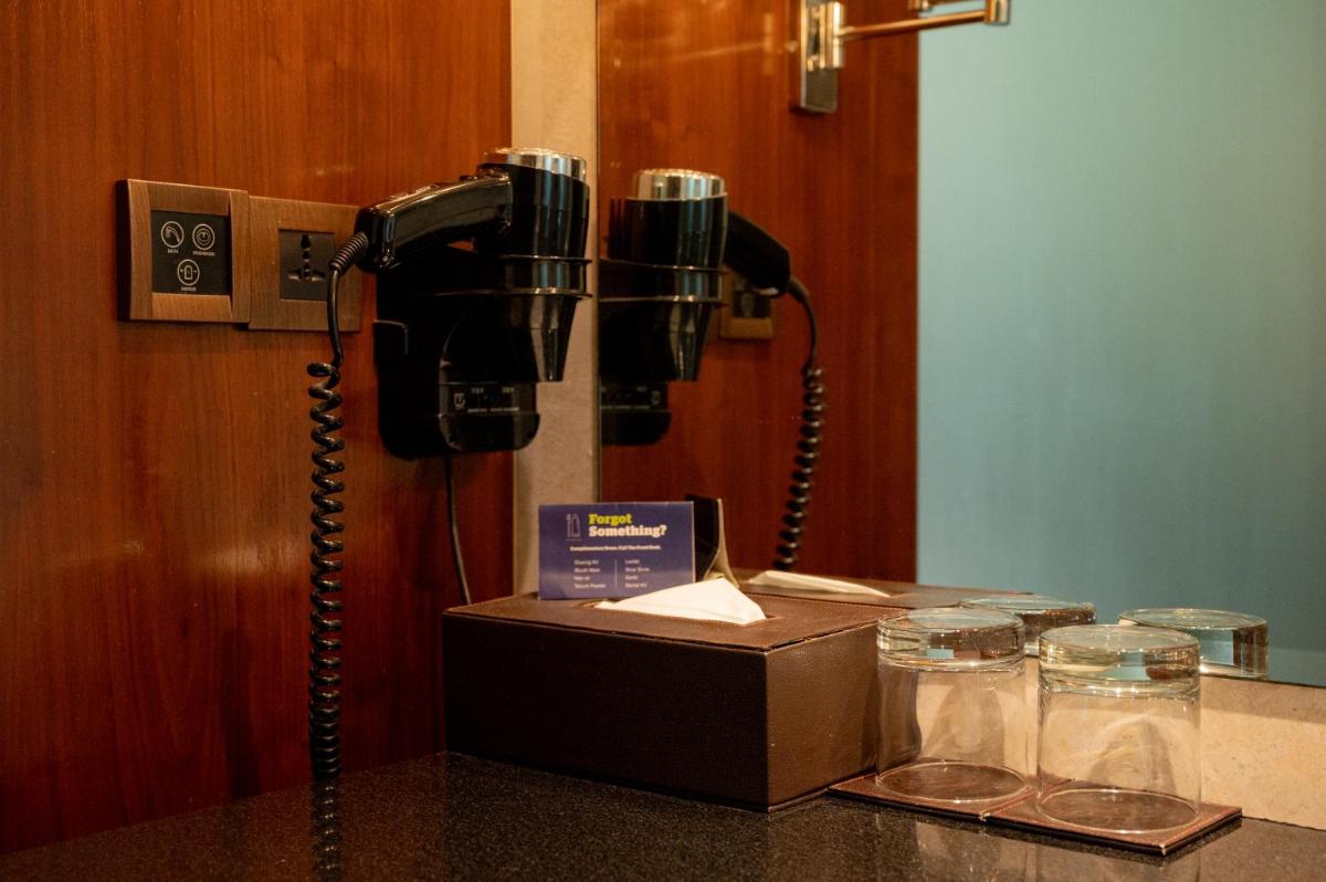 a phone on a table in a room at DoubleTree by Hilton-Pune Chinchwad in Pune