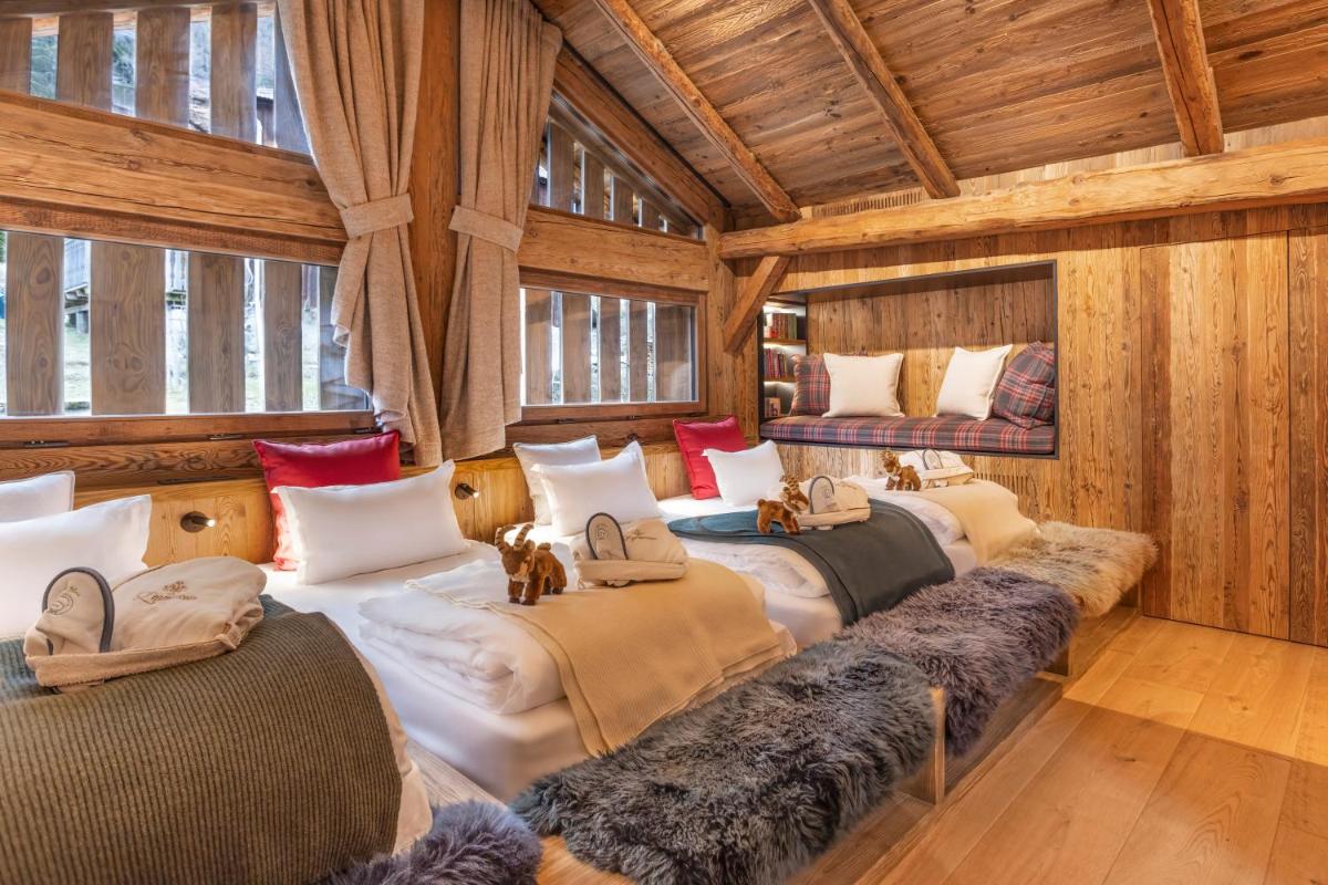 Cette chambre dispose de 4 lits et de murs en bois. dans l'établissement Armancette - The Leading Hotels of the World, à Saint-Gervais-les-Bains 95 autres photos