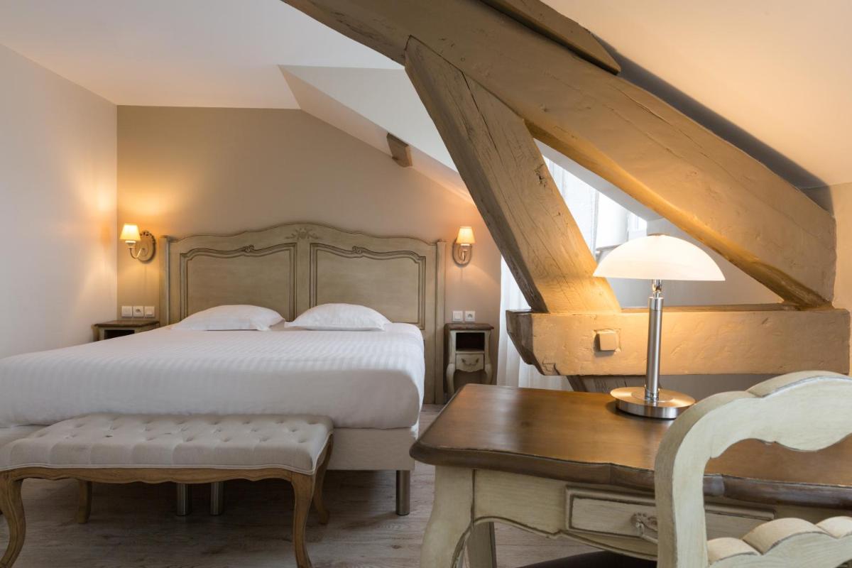 une chambre avec un lit, une table et un bureau dans l'établissement The Originals Boutique, Hôtel Les Poèmes de Chartres, à Chartres
