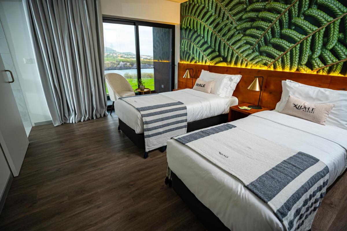 Uma cama ou camas num quarto em Xhale Azores