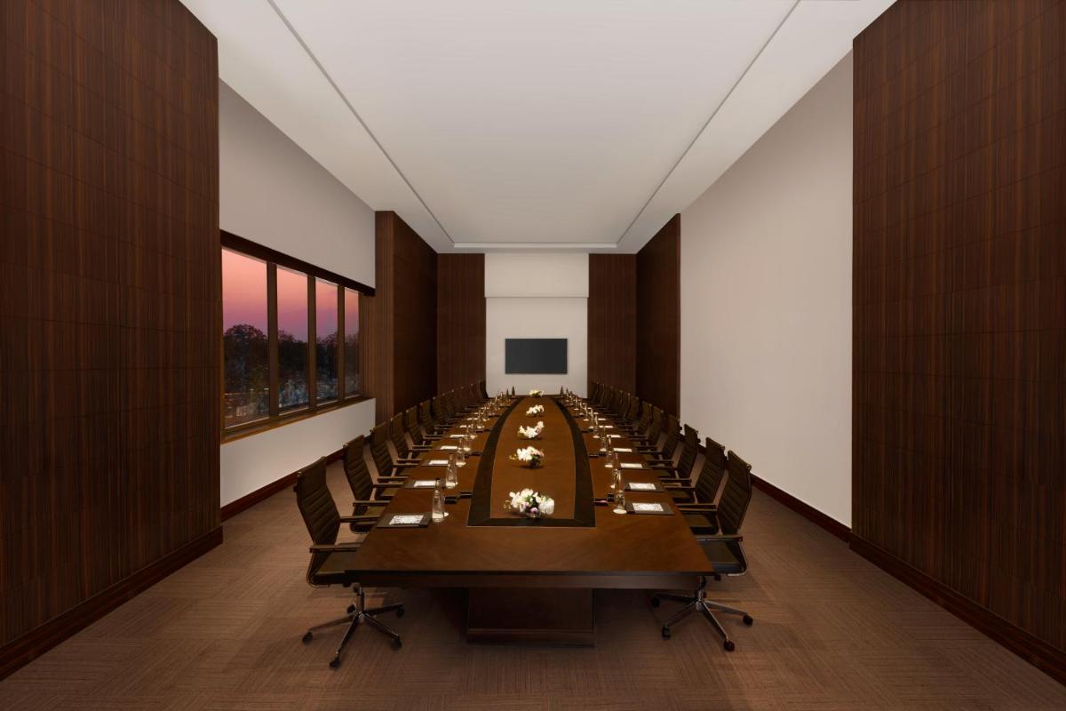 a long conference room with a long table and chairs at Novotel Jaipur Convention Centre in Jaipur