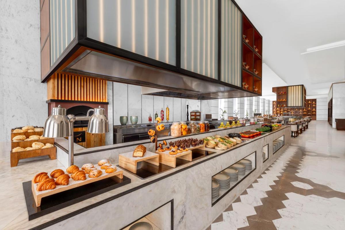 a bakery with lots of different types of bread at Novotel Jaipur Convention Centre in Jaipur