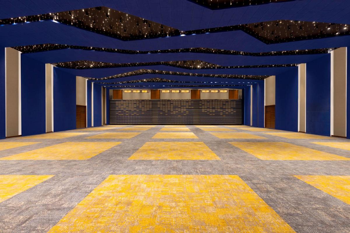 a large room with blue walls and a yellow floor at Novotel Jaipur Convention Centre in Jaipur