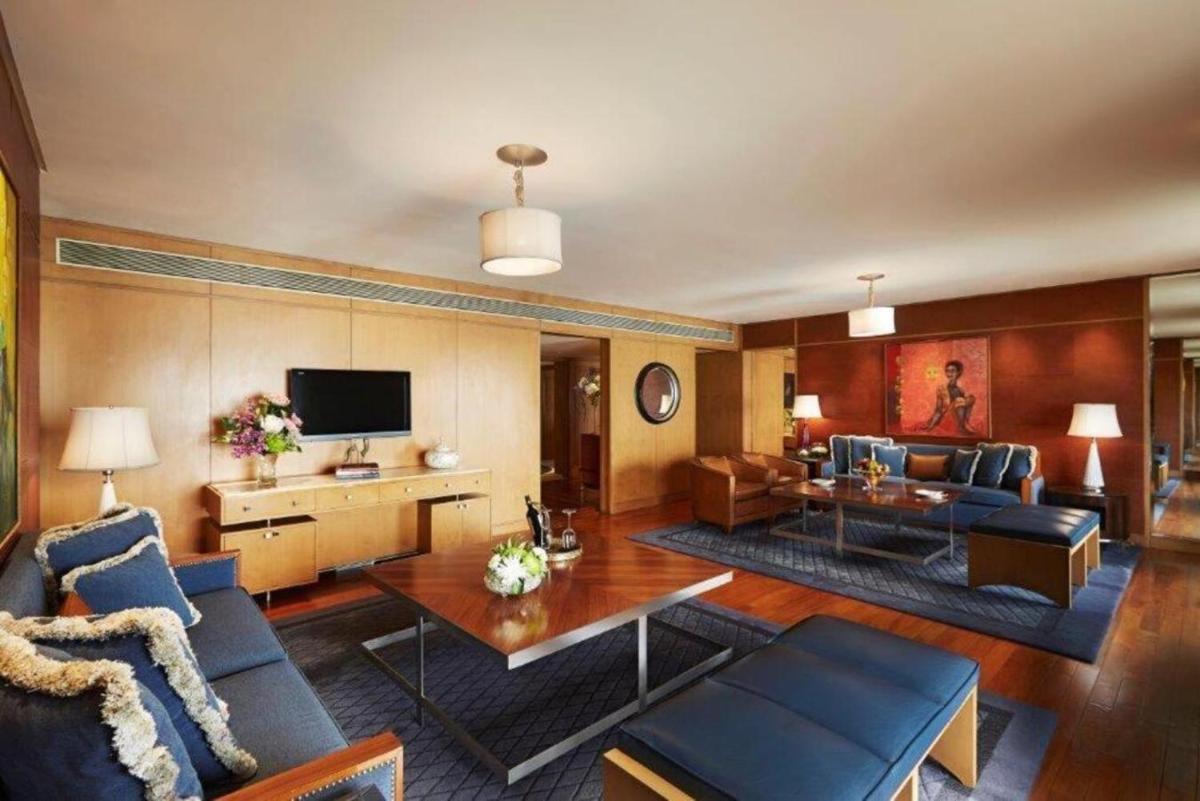 a living room with a couch and a table at Taj Lands End in Mumbai a living room with a couch and a table at Taj Lands End in Mumbai