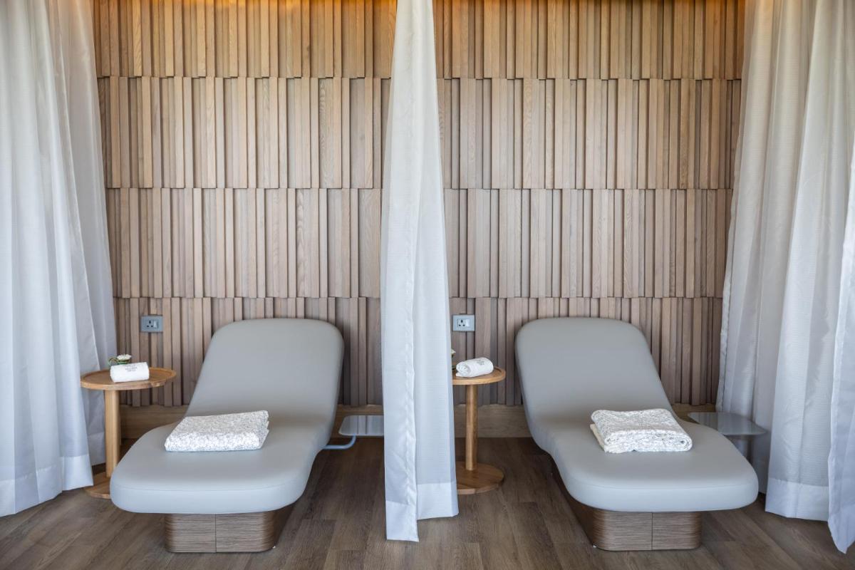 two chairs in a waiting room with curtains at Taj Lands End in Mumbai two chairs in a waiting room with curtains at Taj Lands End in Mumbai