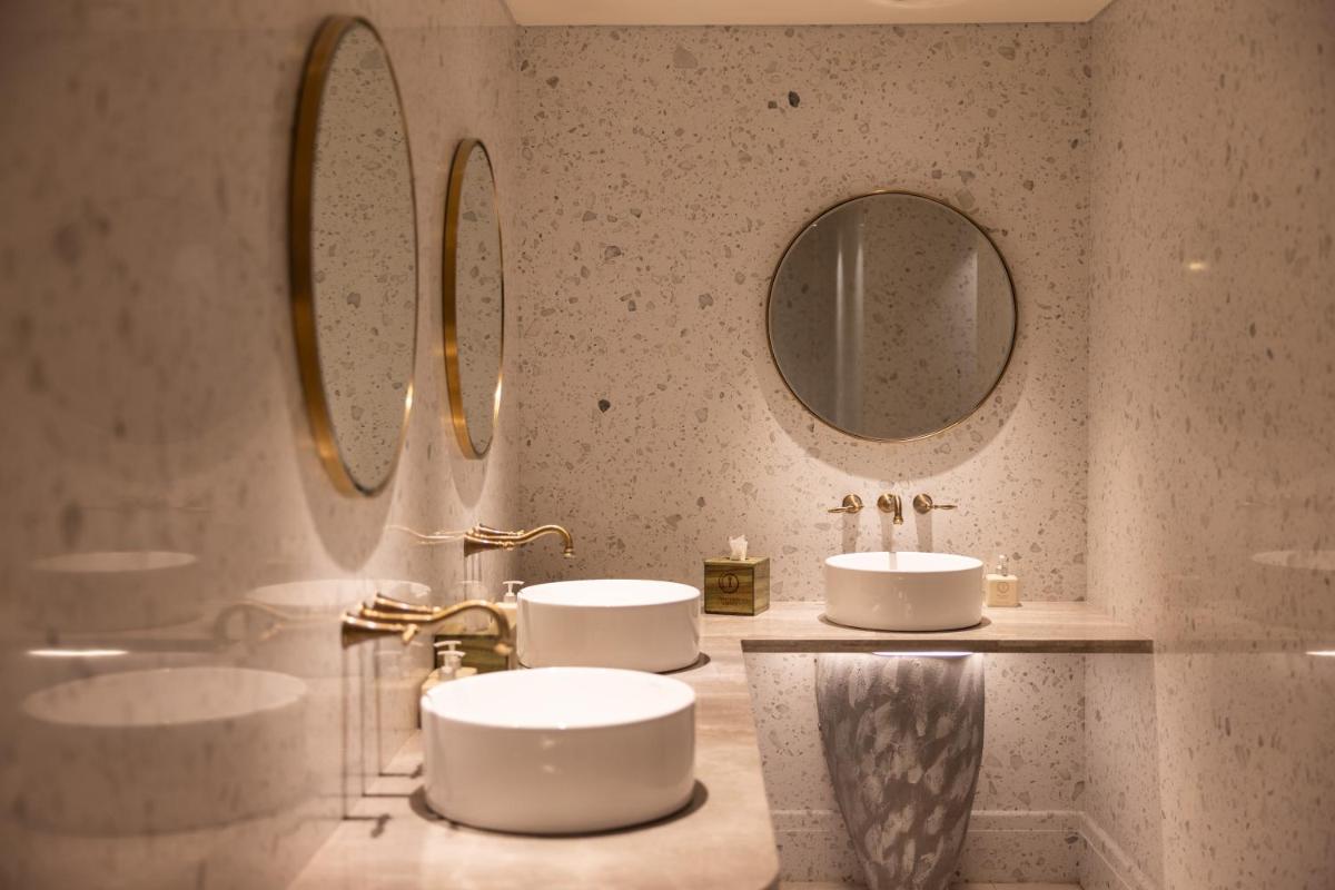 a bathroom with two sinks and two mirrors at Taj Lands End in Mumbai a bathroom with two sinks and two mirrors at Taj Lands End in Mumbai