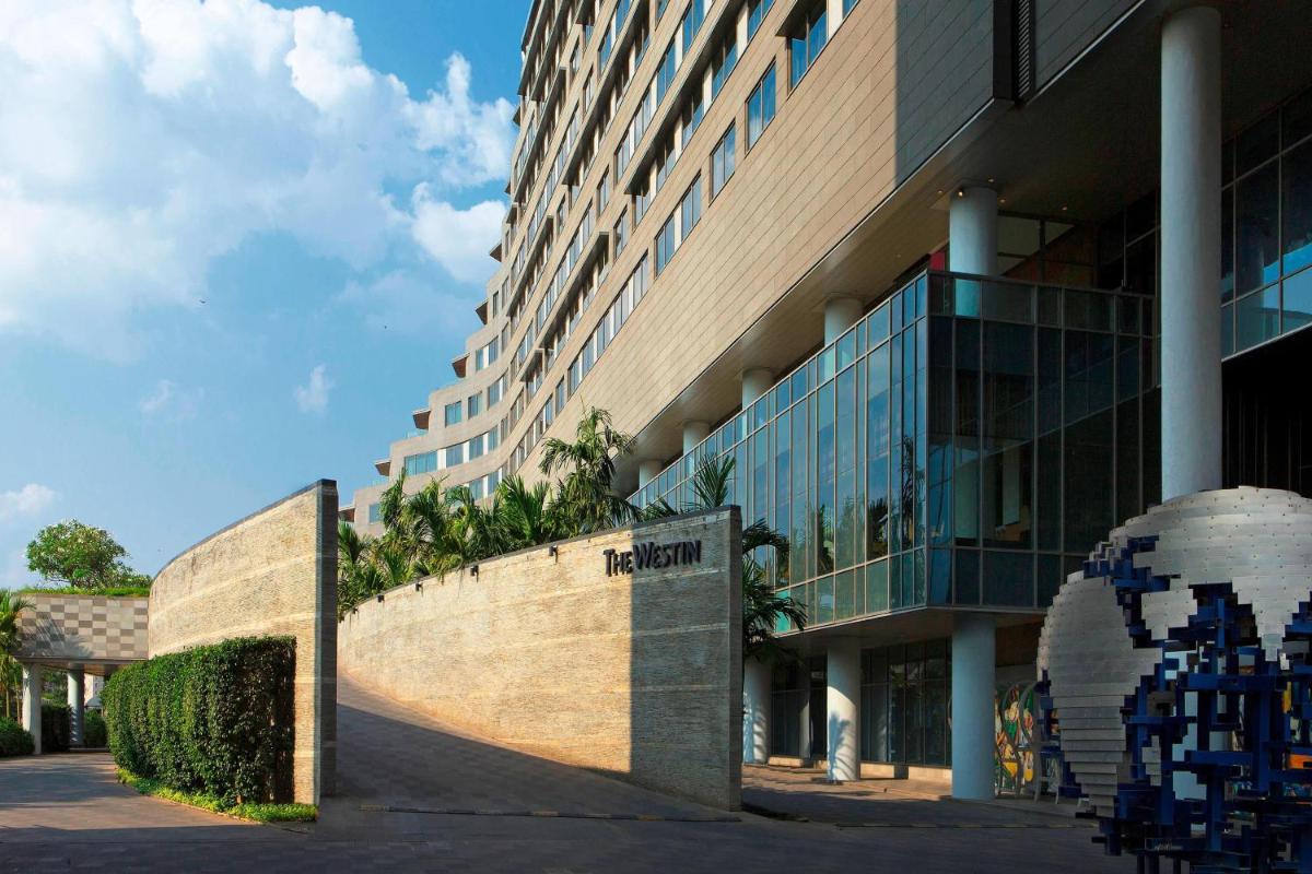 a building with a sign in front of it at The Westin Pune Koregaon Park in Pune