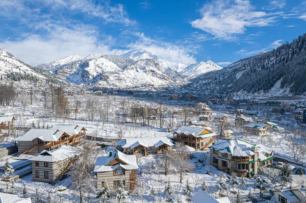 a town covered in snow with mountains in the background at Storii By ITC Hotels Urvashis Retreat, Manali in Manāli a town covered in snow with mountains in the background at Storii By ITC Hotels Urvashis Retreat, Manali in Manāli