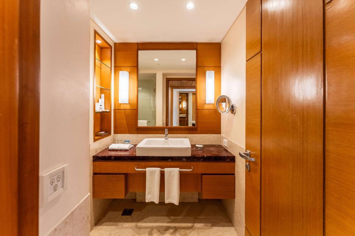 a bathroom with a sink and a mirror at Radisson Blu Hotel, Indore in Indore
