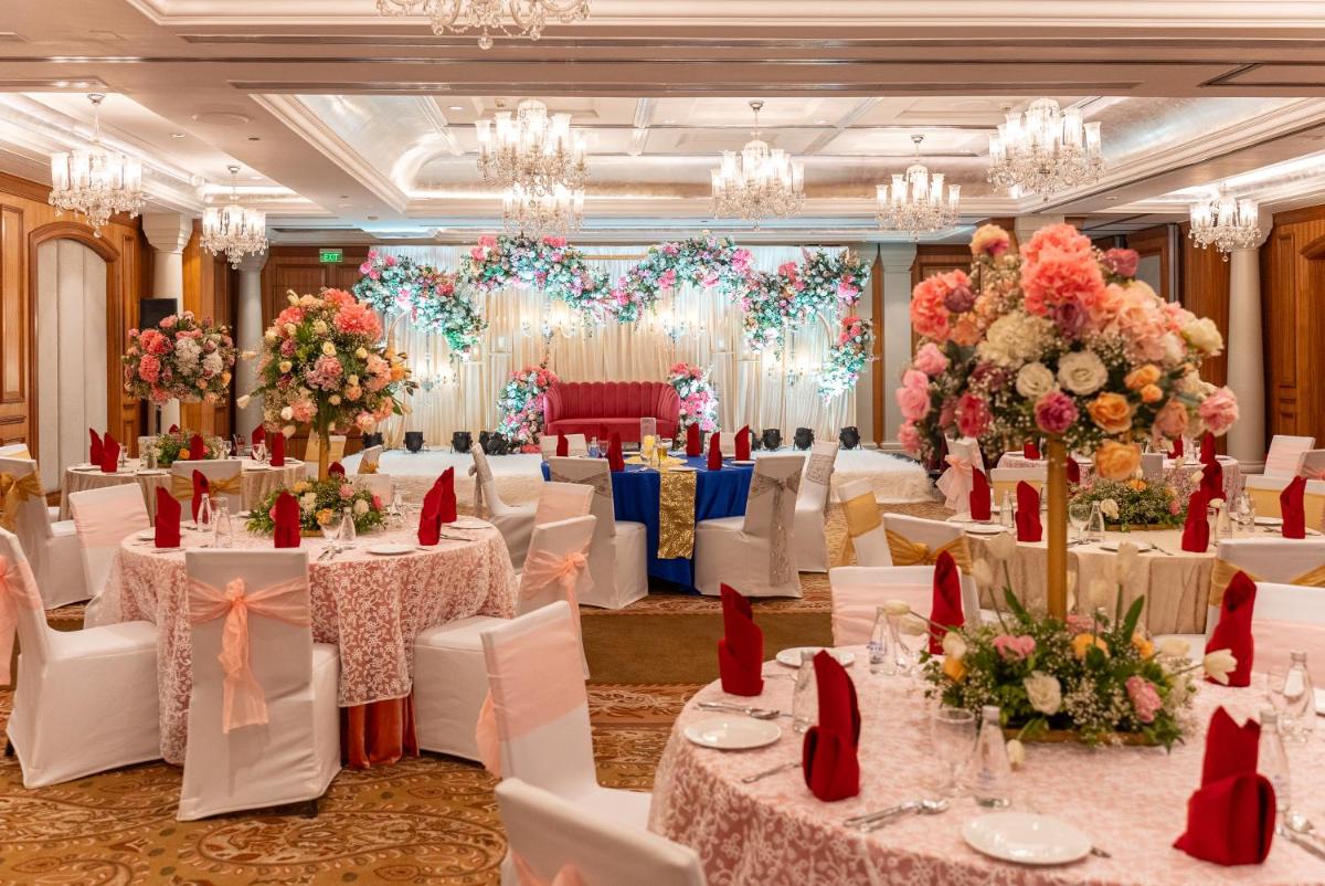 a banquet hall with white tables and chairs and flowers at Hilton Mumbai International Airport Hotel in Mumbai