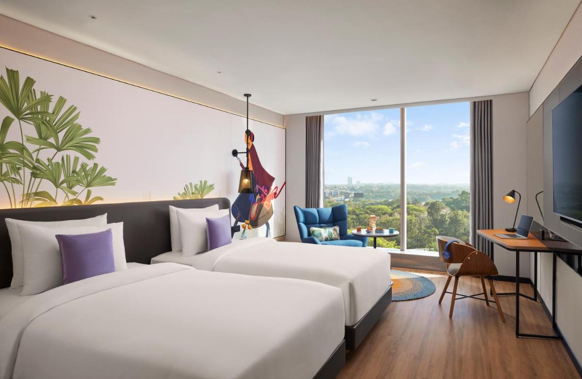 a hotel room with two beds and a large window at Hyatt Centric Hebbal Bengaluru in Bengaluru