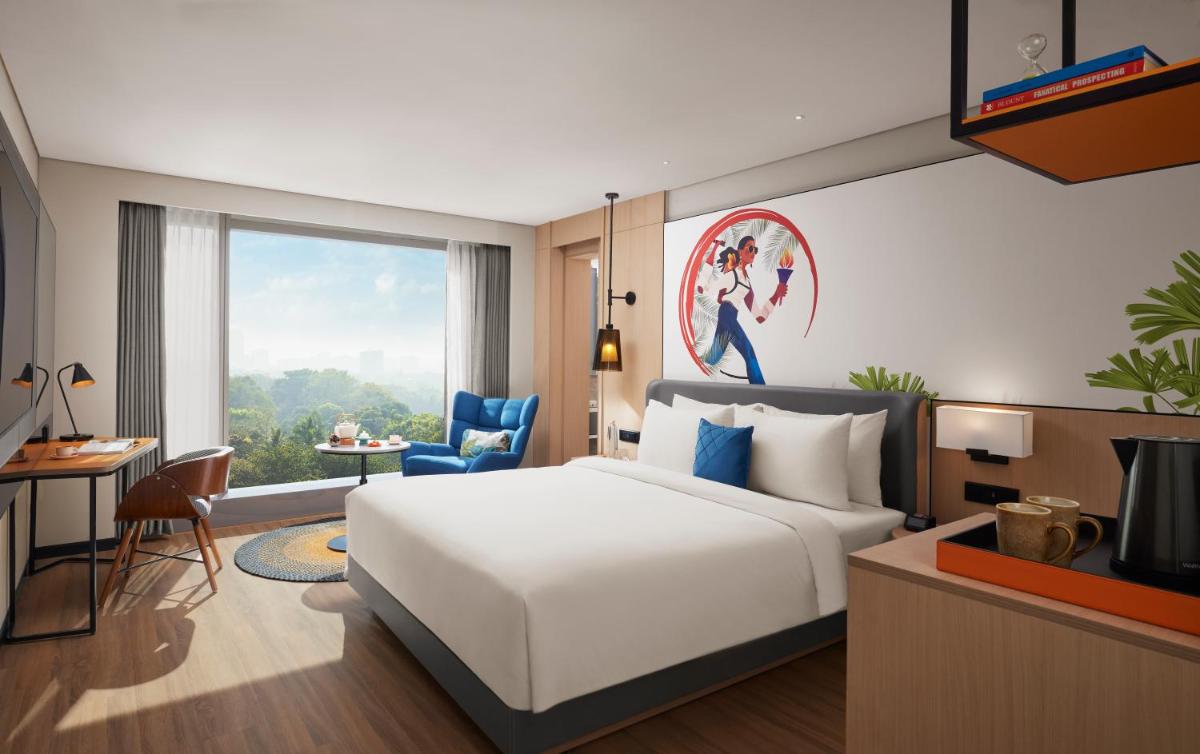 a bedroom with a white bed and a large window at Hyatt Centric Hebbal Bengaluru in Bengaluru