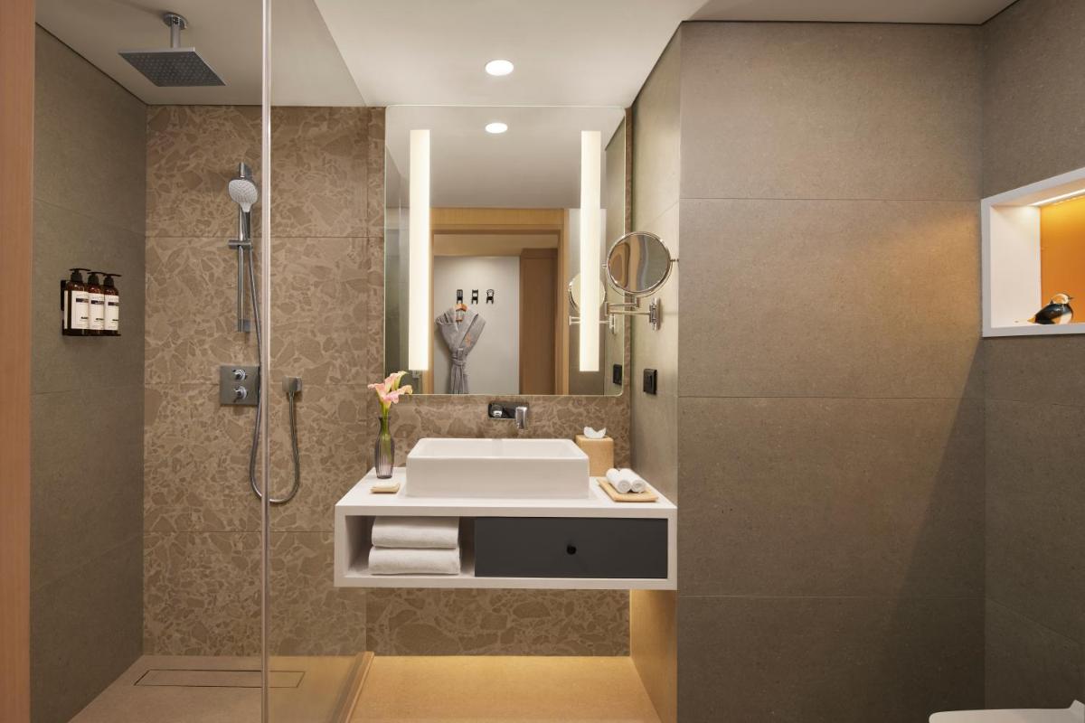 a bathroom with a sink and a shower at Hyatt Centric Hebbal Bengaluru in Bengaluru