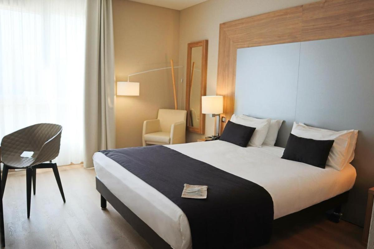 Un ou plusieurs lits dans un hébergement de l'établissement 7Hotel&Spa
