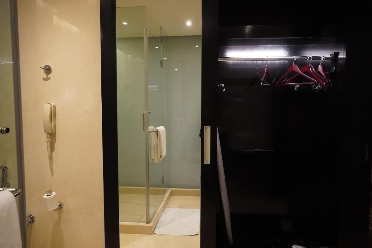 a bathroom with a shower and a glass door at Crowne Plaza Pune City Centre by IHG in Pune