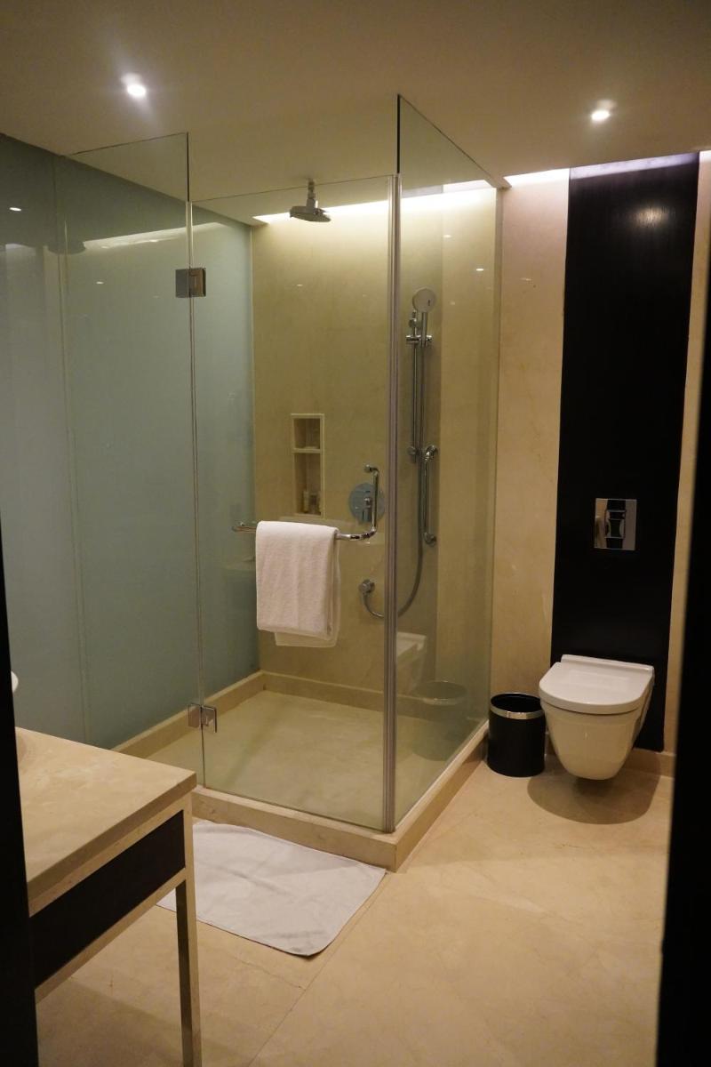 a bathroom with a glass shower and a toilet at Crowne Plaza Pune City Centre by IHG in Pune