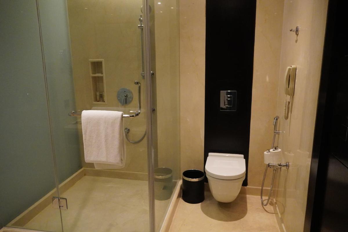 a bathroom with a glass shower with a toilet at Crowne Plaza Pune City Centre by IHG in Pune