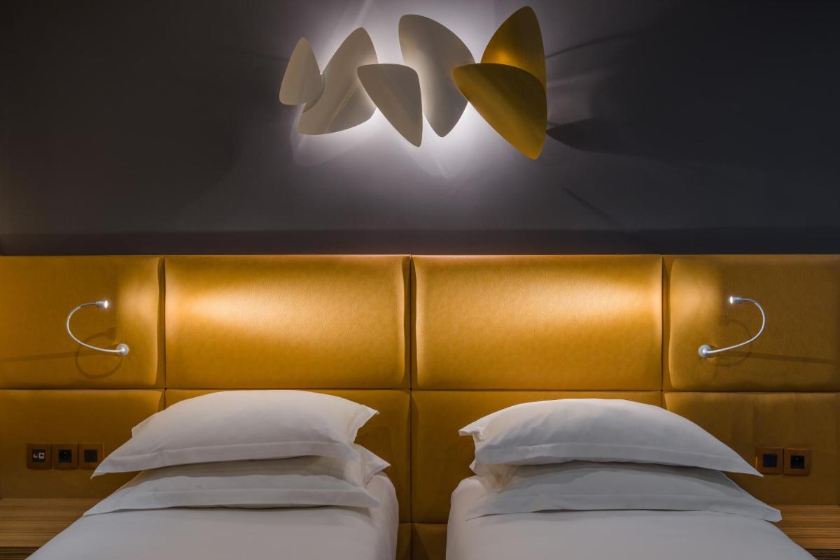 Un ou plusieurs lits dans un hébergement de l'établissement Hotel Residence Europe & Spa