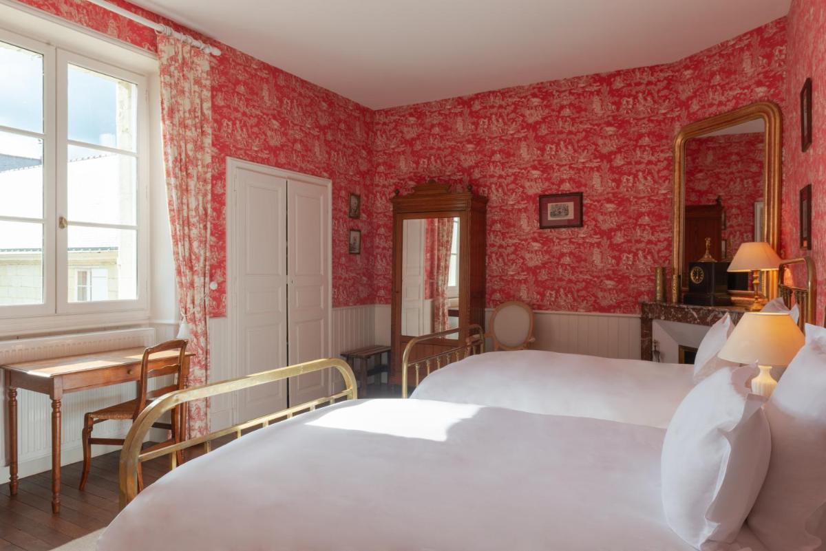 Un ou plusieurs lits dans un hébergement de l'établissement Le Domaine de Mestré, The Originals Relais
