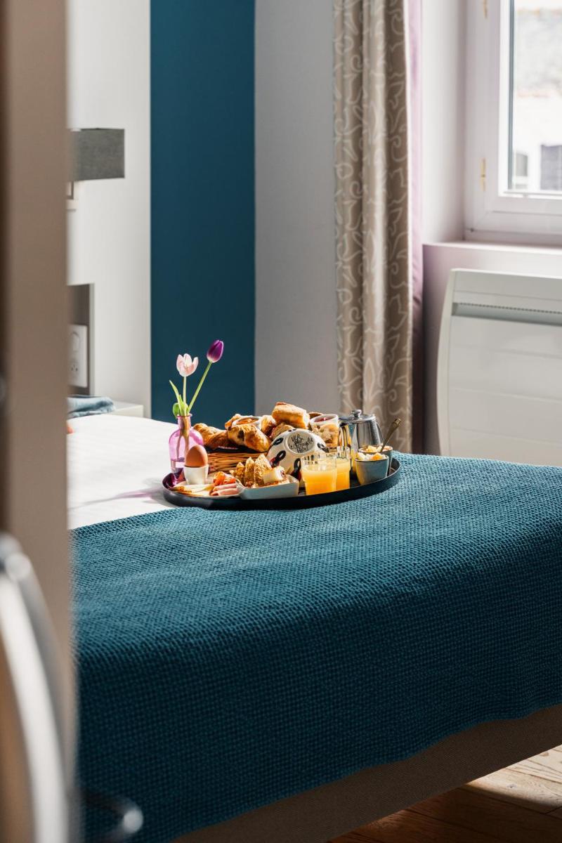Un ou plusieurs lits dans un hébergement de l'établissement Le Cornouaille Hotel & Spa