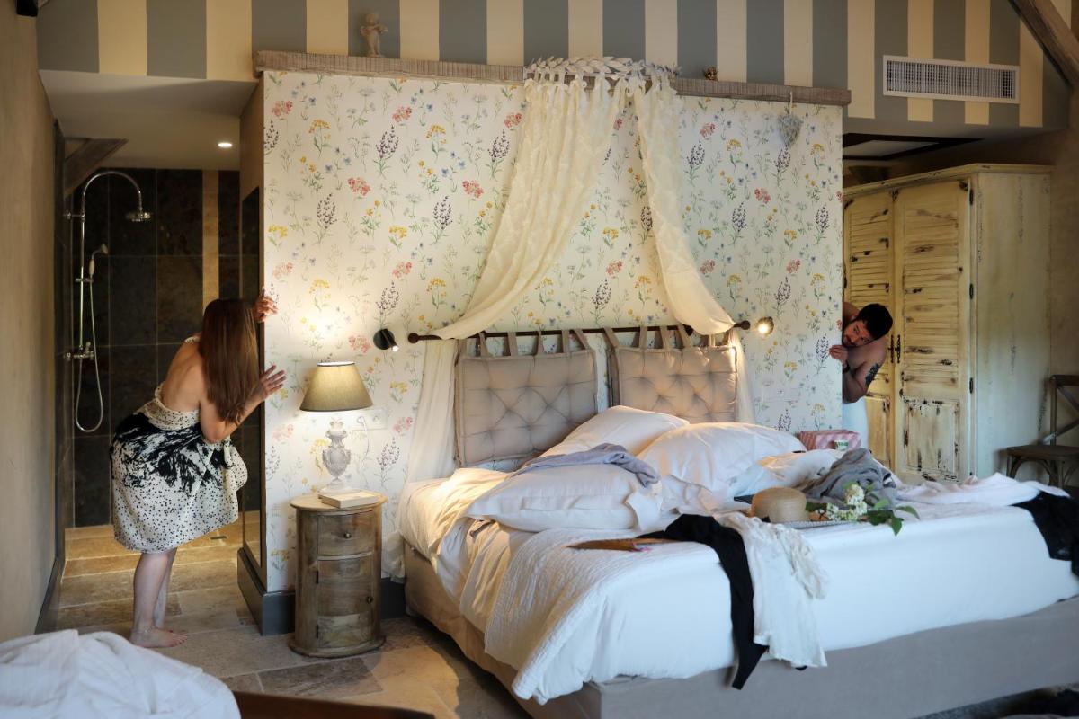 Un ou plusieurs lits dans un hébergement de l'établissement Hôtel-Spa Le Saint Cirq