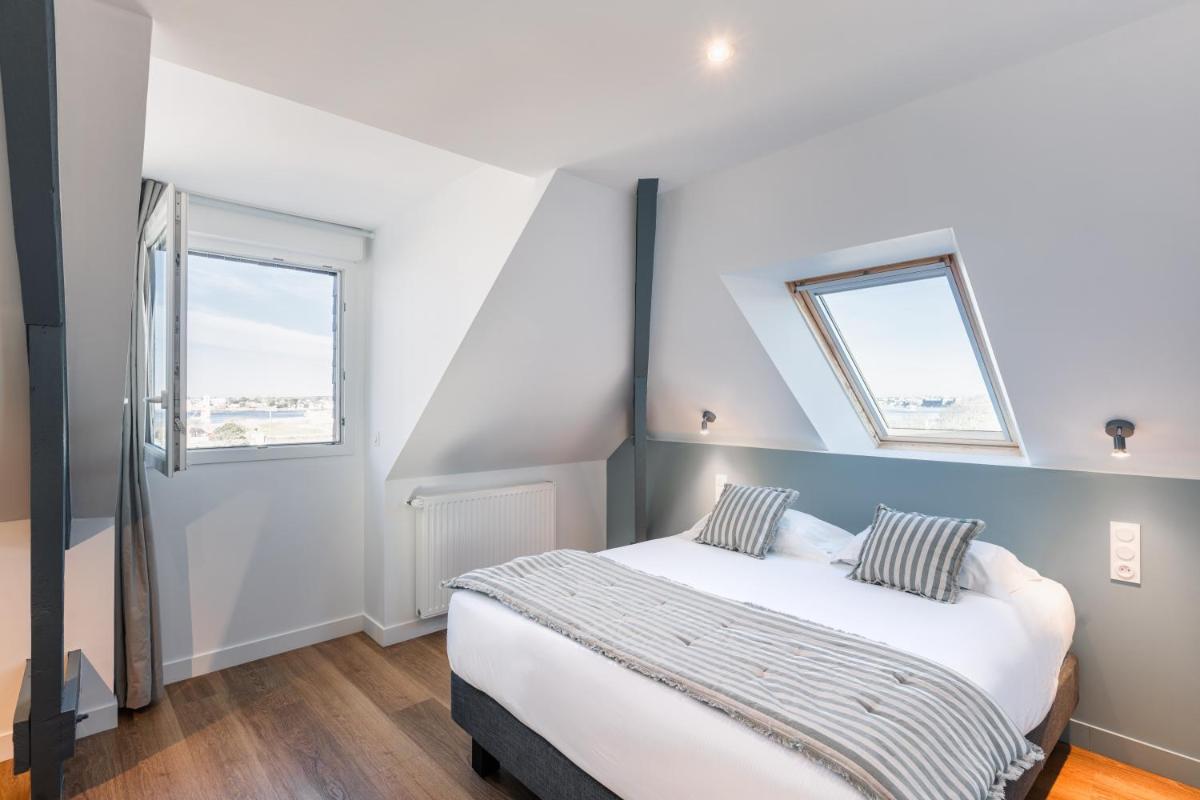 Un ou plusieurs lits dans un hébergement de l'établissement Hôtel Spa De La Citadelle Lorient