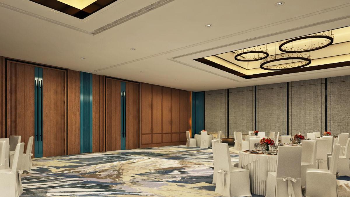 a conference room with white chairs and tables in it at Hyatt Centric Hebbal Bengaluru in Bengaluru