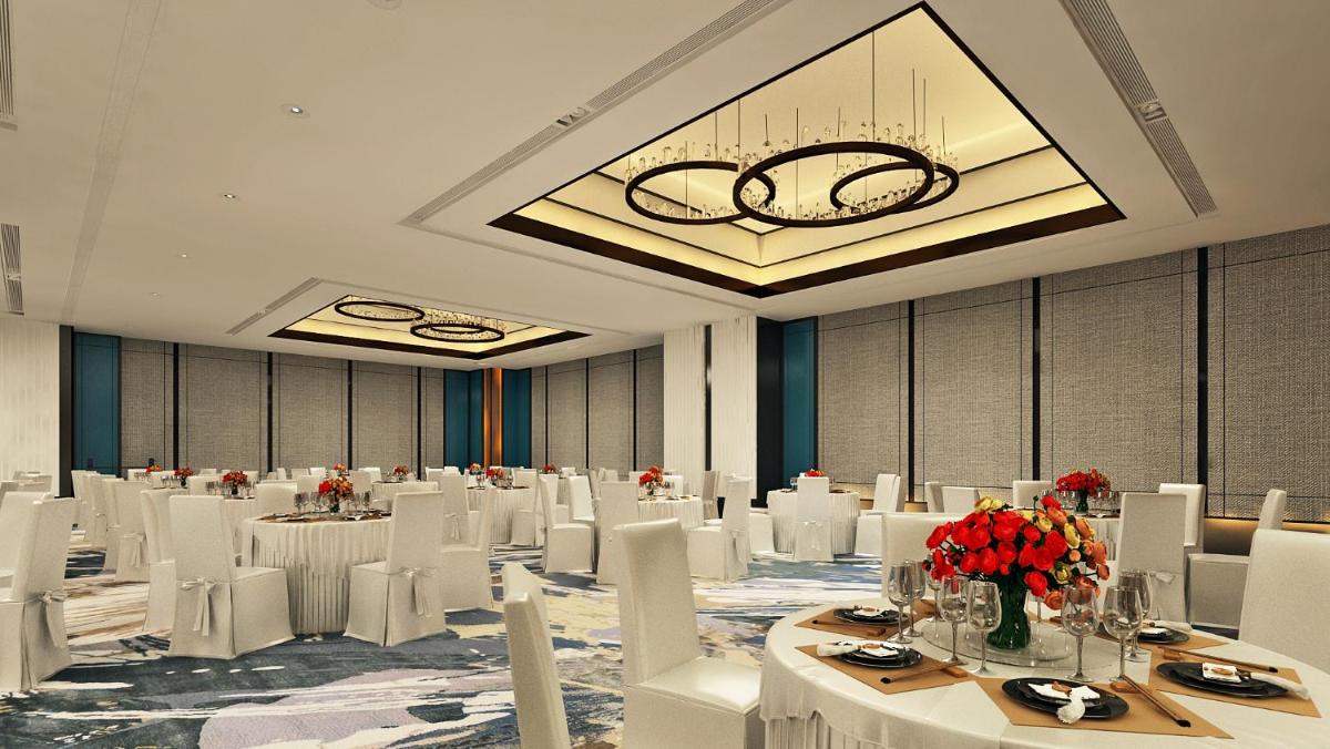 a banquet hall with white tables and white chairs at Hyatt Centric Hebbal Bengaluru in Bengaluru