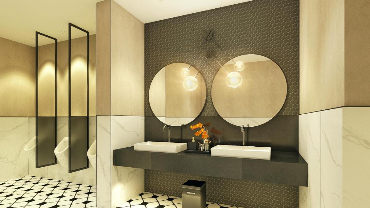 a bathroom with two sinks and two mirrors at Hyatt Centric Hebbal Bengaluru in Bengaluru