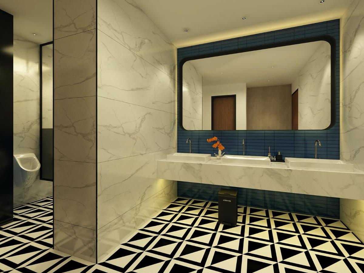 a bathroom with a large mirror and a sink at Hyatt Centric Hebbal Bengaluru in Bengaluru