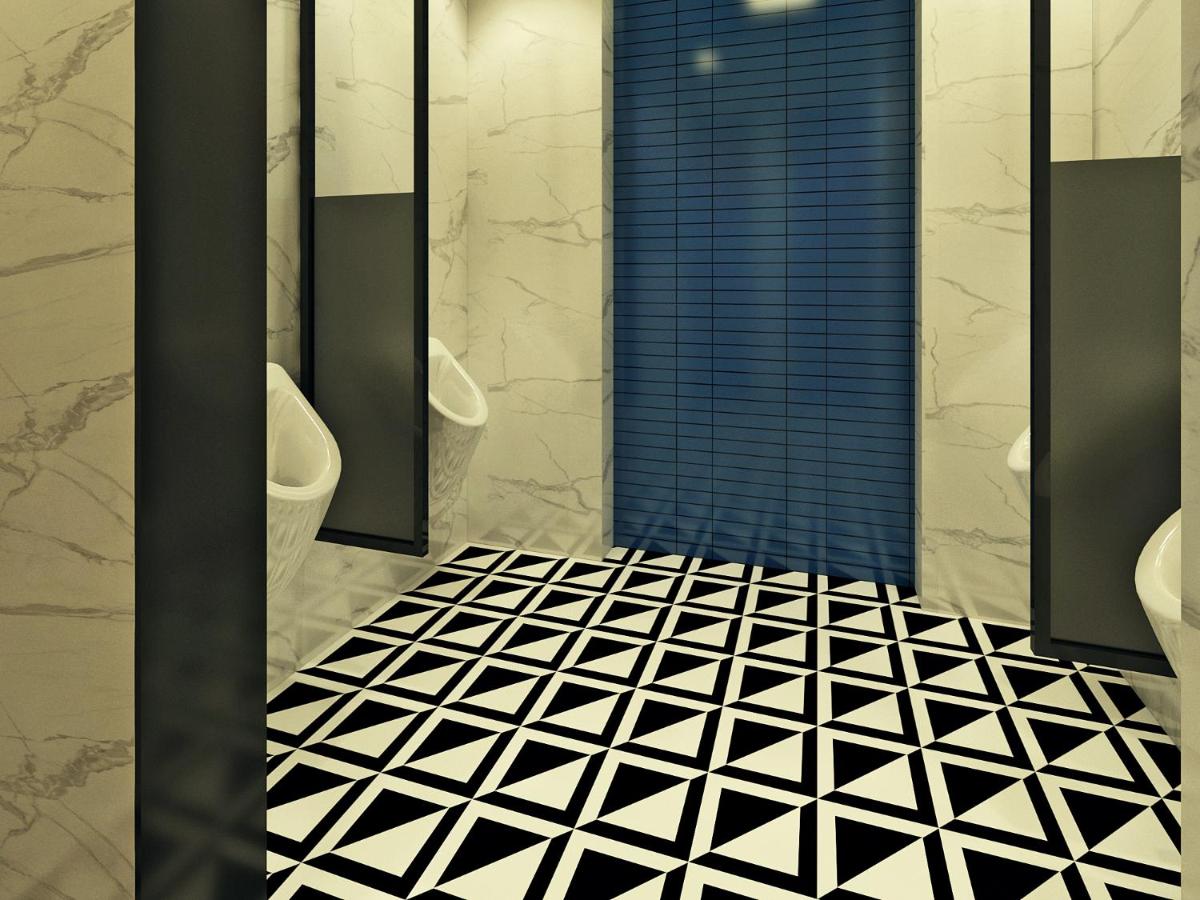 a bathroom with two sinks and two toilets and a shower at Hyatt Centric Hebbal Bengaluru in Bengaluru