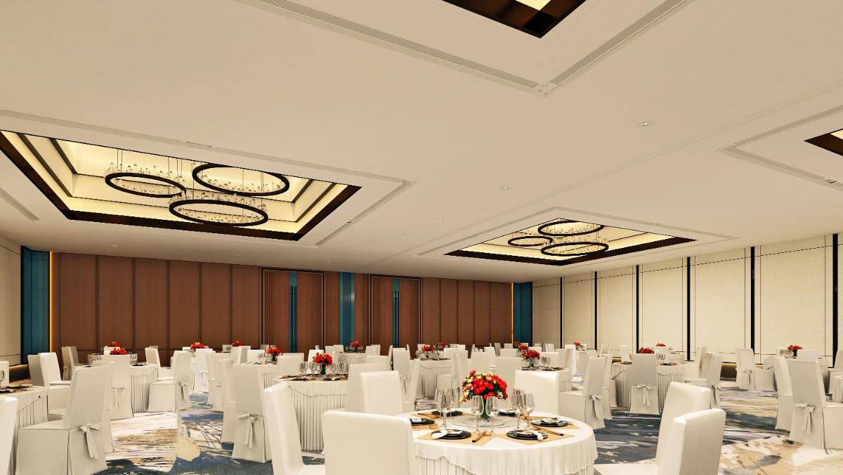 a banquet hall with white tables and white chairs at Hyatt Centric Hebbal Bengaluru in Bengaluru