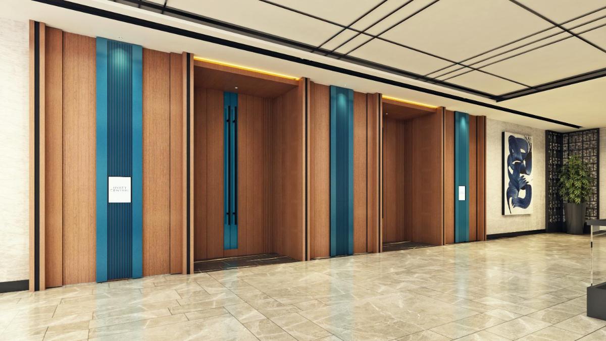 a hallway with wooden doors in a building at Hyatt Centric Hebbal Bengaluru in Bengaluru